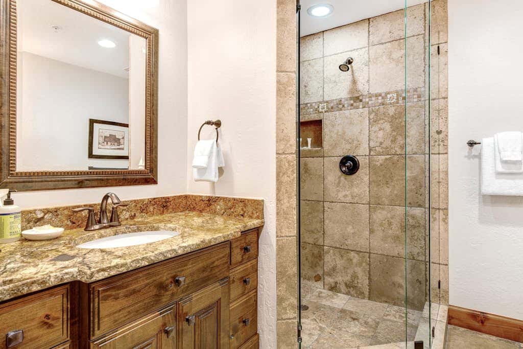 Luxury Deer Valley condo featuring a private hot tub and cozy stone fireplace.