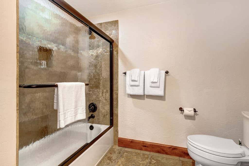 Luxury Deer Valley condo featuring a private hot tub and cozy stone fireplace.