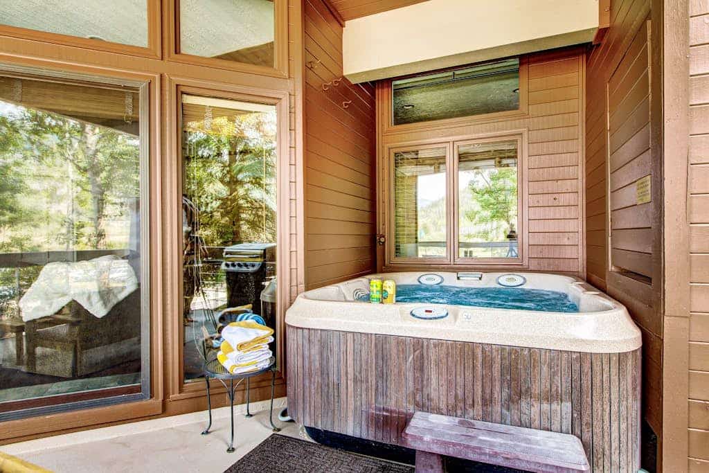 Luxury Deer Valley condo featuring a private hot tub and cozy stone fireplace.