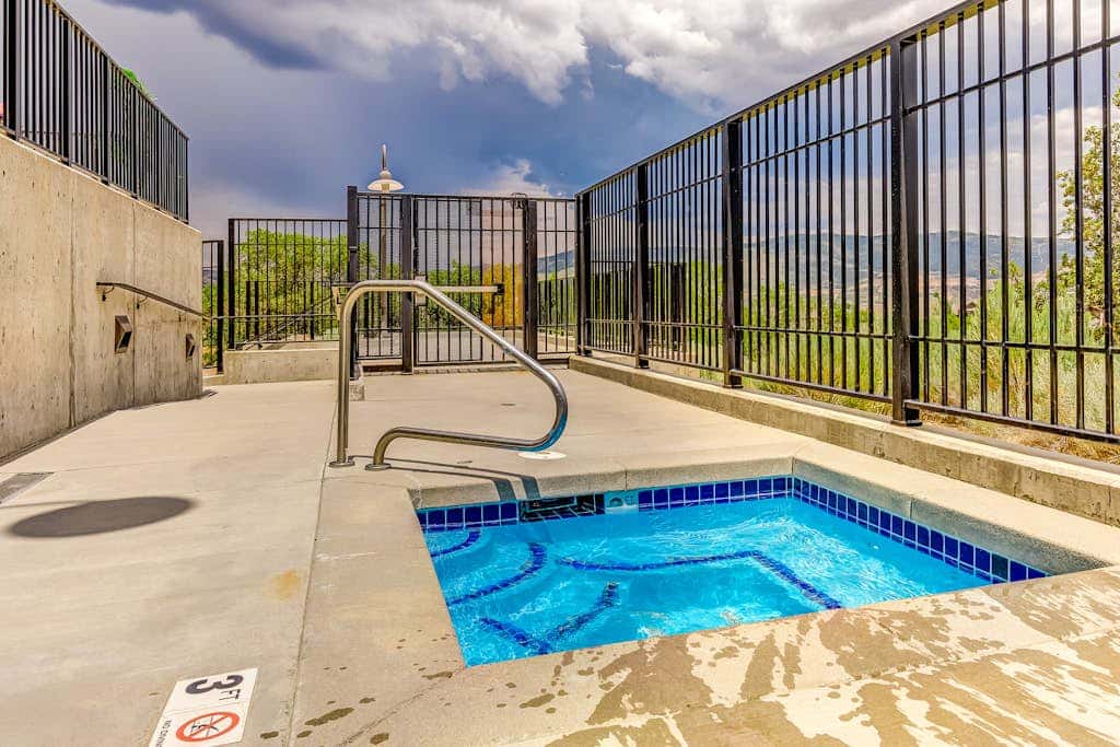 Plush condo with pool, gym, hot tubs, garage & central AC - snowbird-friendly