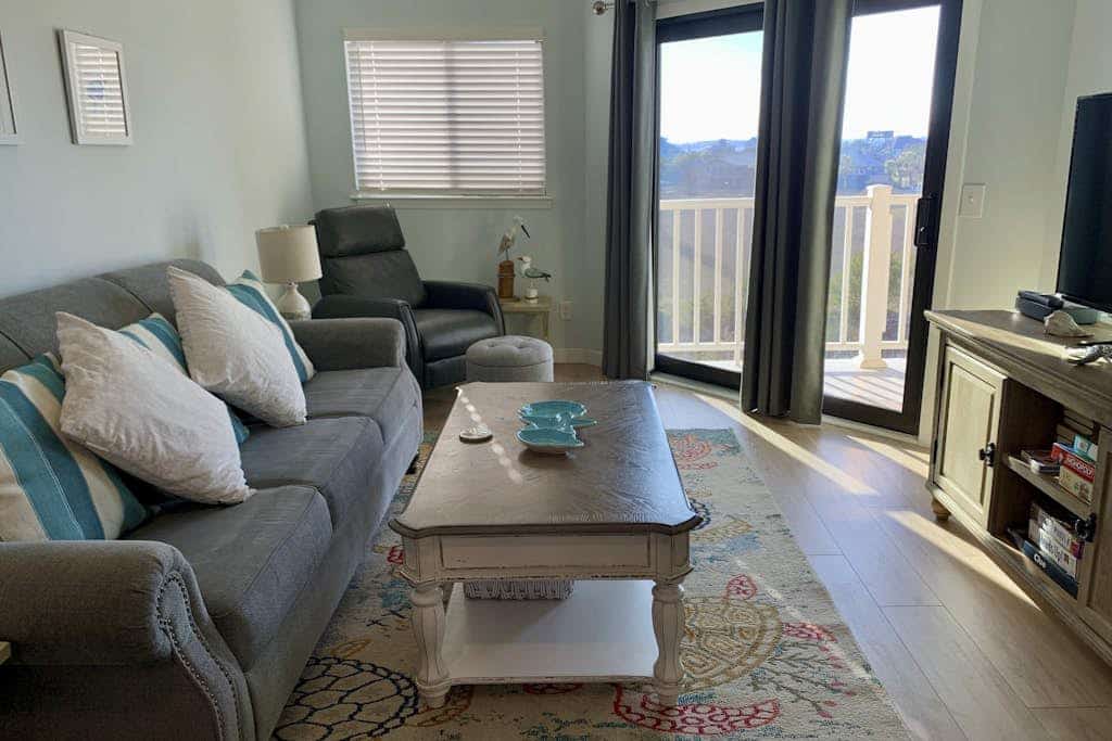 Inviting waterfront condo with marsh view, shared pool, balcony & central AC