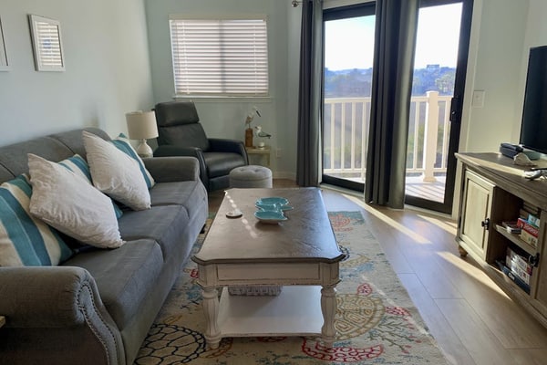 Inviting waterfront condo with marsh view, shared pool, balcony & central AC