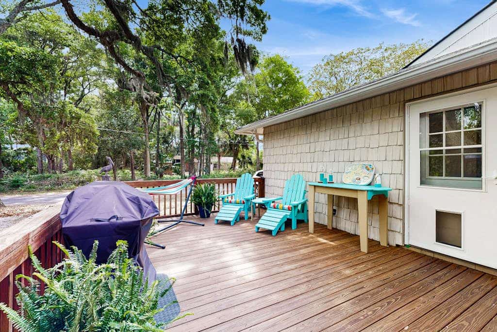 Edisto Beach cottage with a screened in porch & nestled among old live oaks