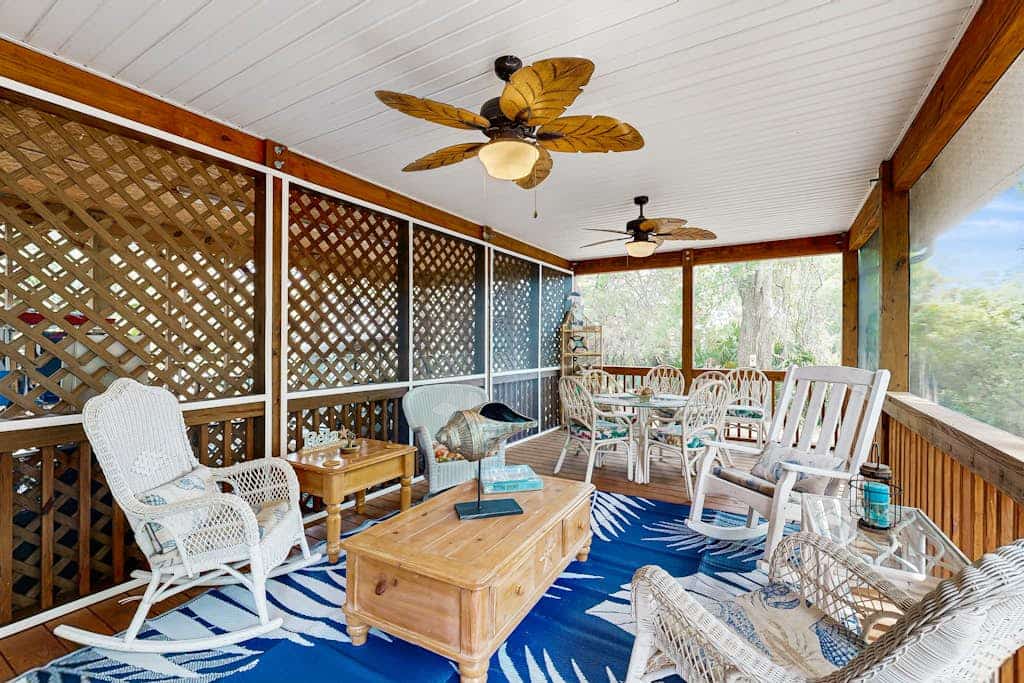 Edisto Beach cottage with a screened in porch & nestled among old live oaks