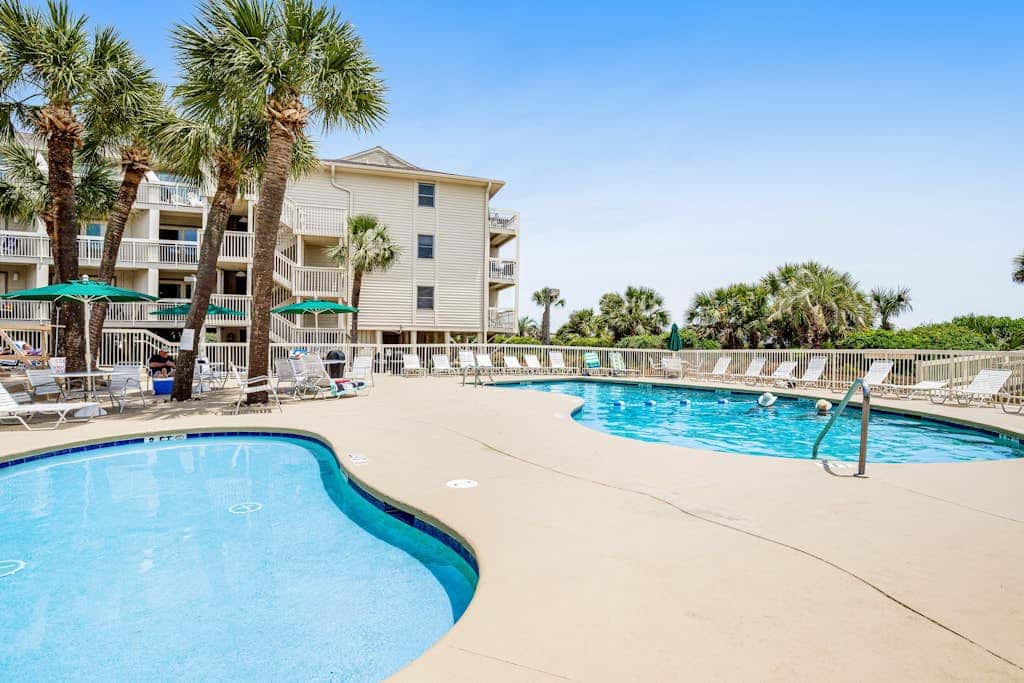 Condo with Coligny Beach views, outdoor pool, beach access, balcony, WD, & AC