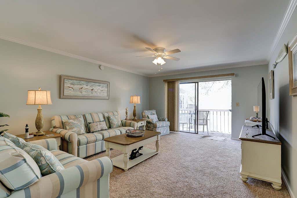 Waterfront condo with seasonal pools, hot tub, balcony, AC, & WD