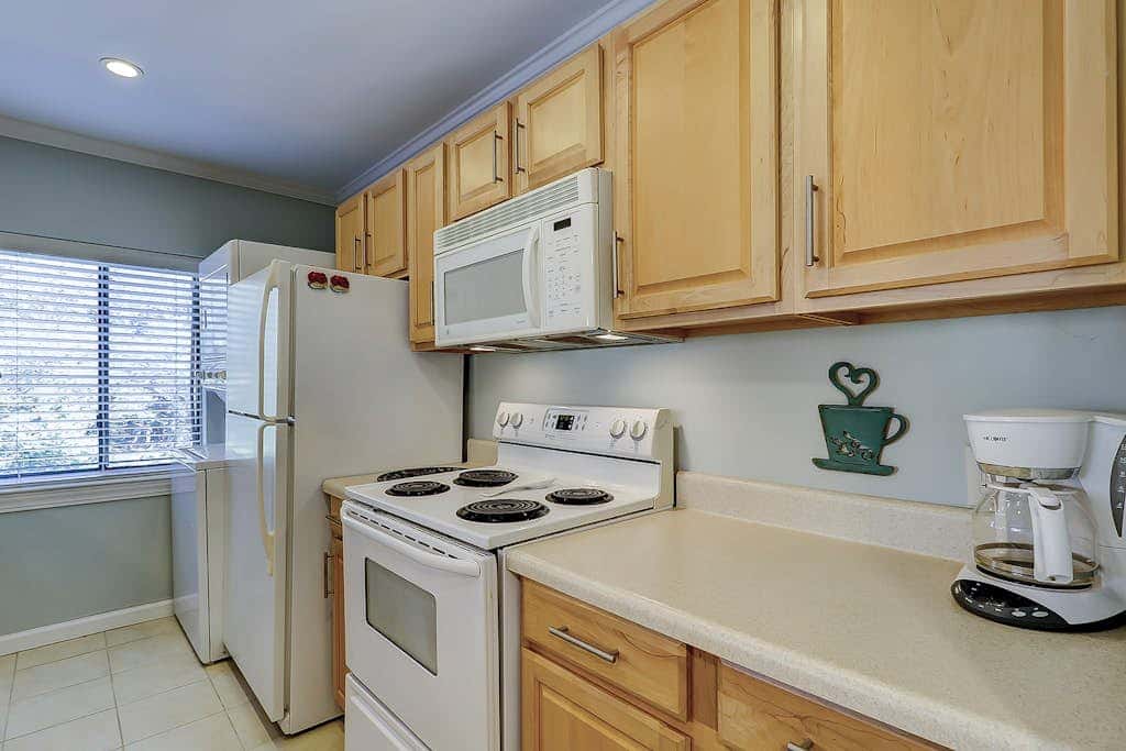 Waterfront condo with seasonal pools, hot tub, balcony, AC, & WD