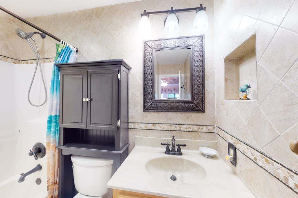 3rd-floor condo with water views, balcony, pools, gym, & beach access