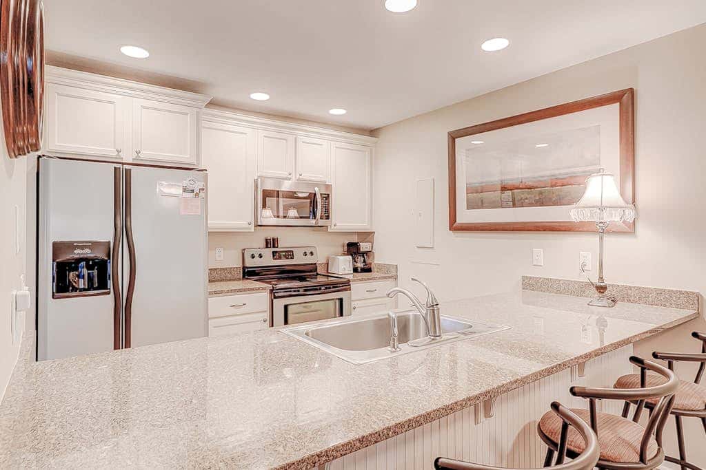 Dog friendly condo with pool, central AC, & washer and dryer, quick walk to beach