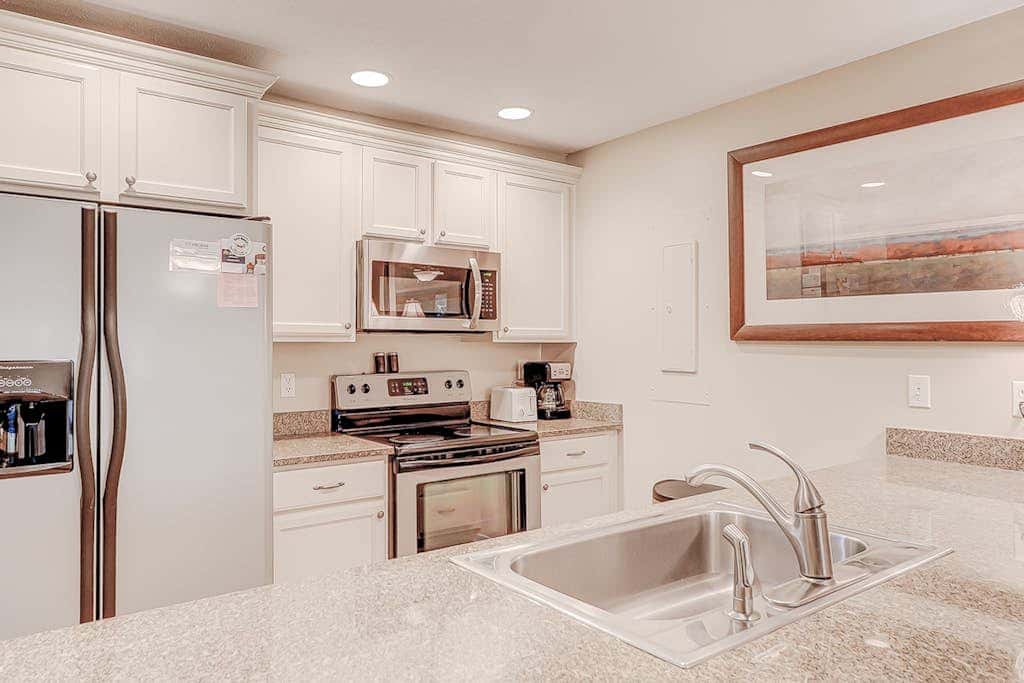 Dog friendly condo with pool, central AC, & washer and dryer, quick walk to beach