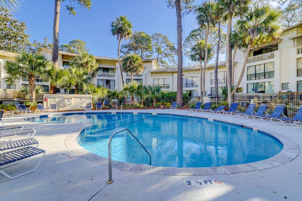 Beach access condo with deck, pool, washer dryer, and AC - snowbird-friendly