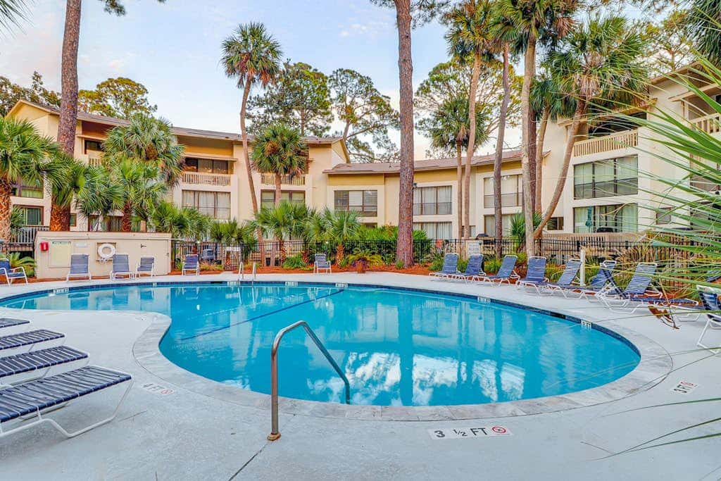 Beach access condo with deck, pool, washer dryer, and AC - snowbird-friendly