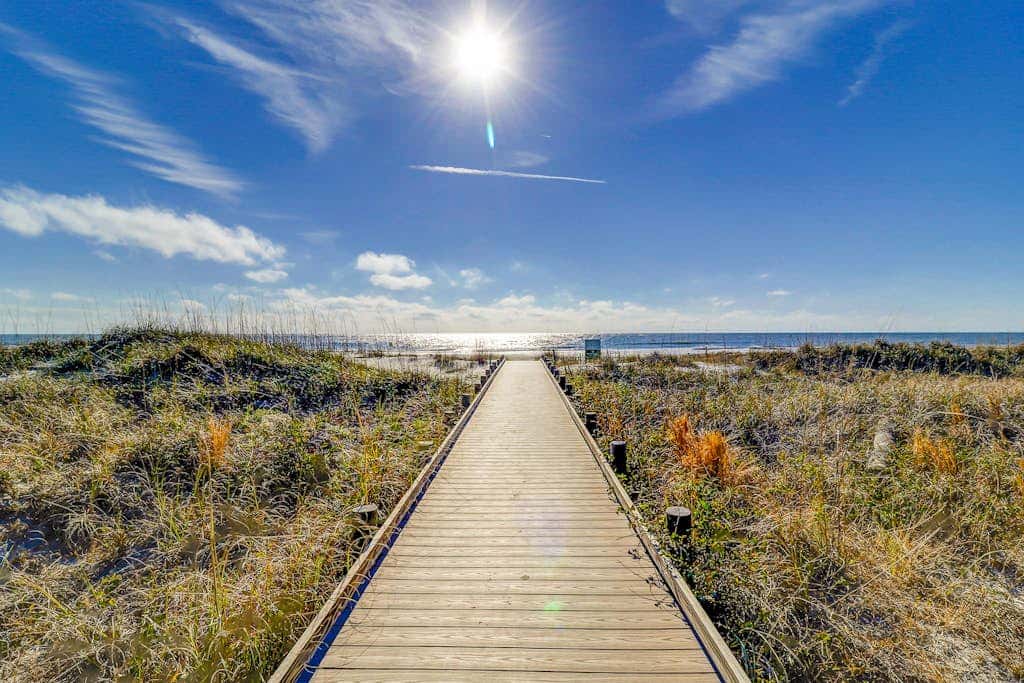 Beach access condo with deck, pool, washer dryer, and AC - snowbird-friendly