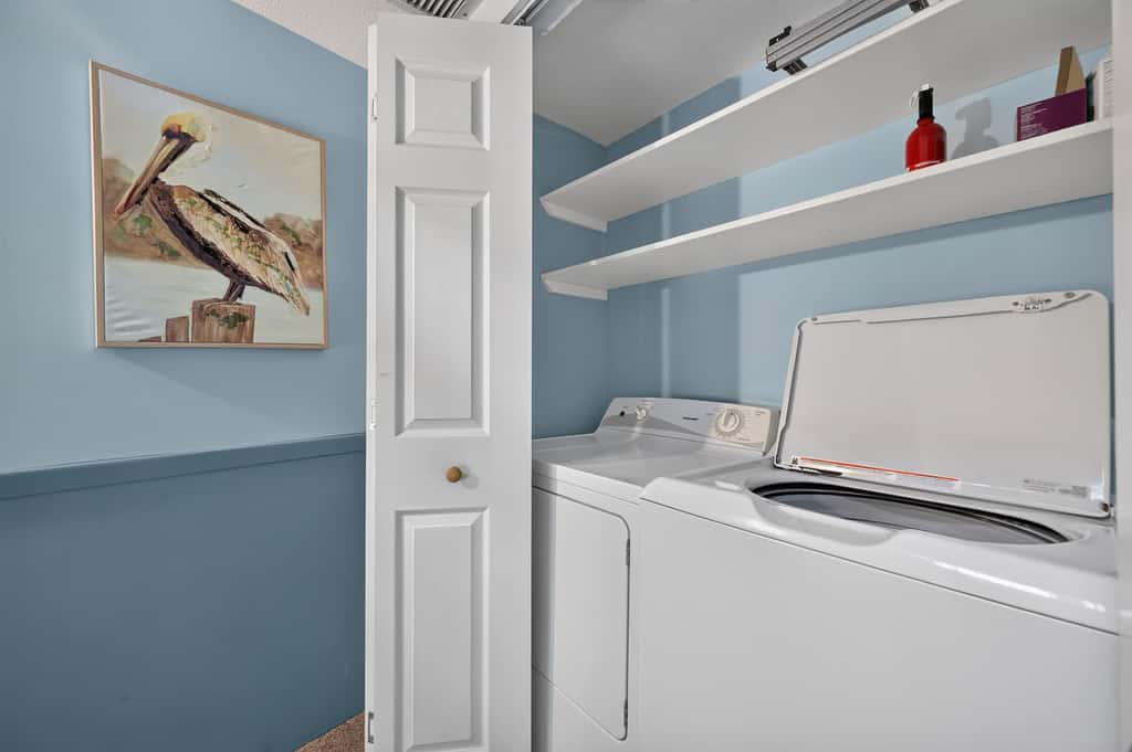 Beach access condo with deck, pool, washer dryer, and AC - snowbird-friendly