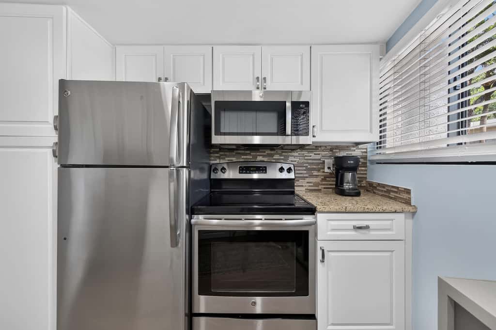 Beach access condo with deck, pool, washer dryer, and AC - snowbird-friendly