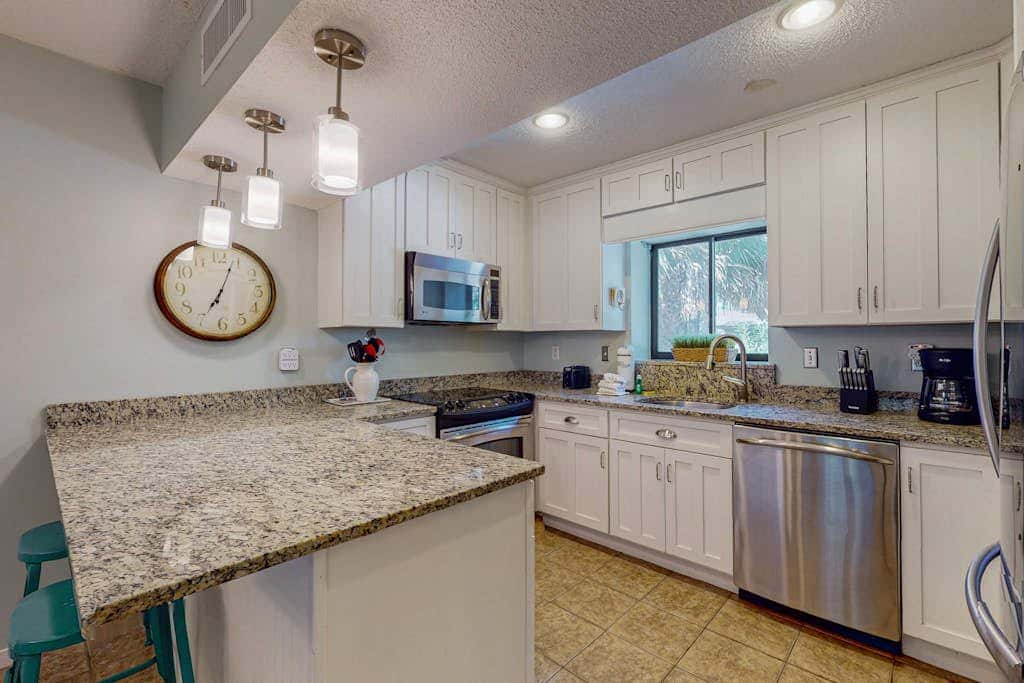 Comfortable two-story Villa with beach access, shared pool, private deck, and washer dryer
