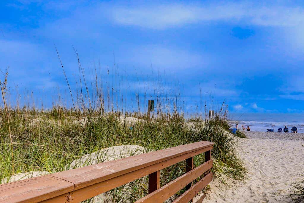 Comfortable two-story Villa with beach access, shared pool, private deck, and washer dryer