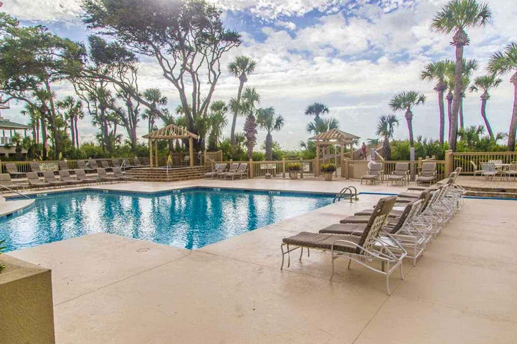 Dreamy condo on the beach with balcony view, shared pool, & charming decor