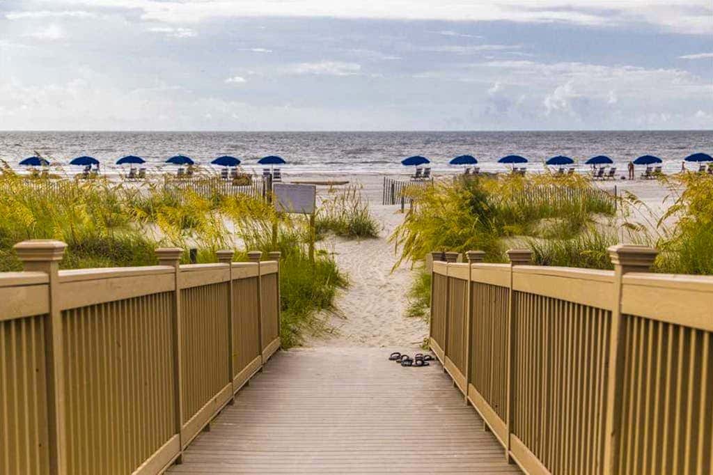 Dreamy condo on the beach with balcony view, shared pool, & charming decor