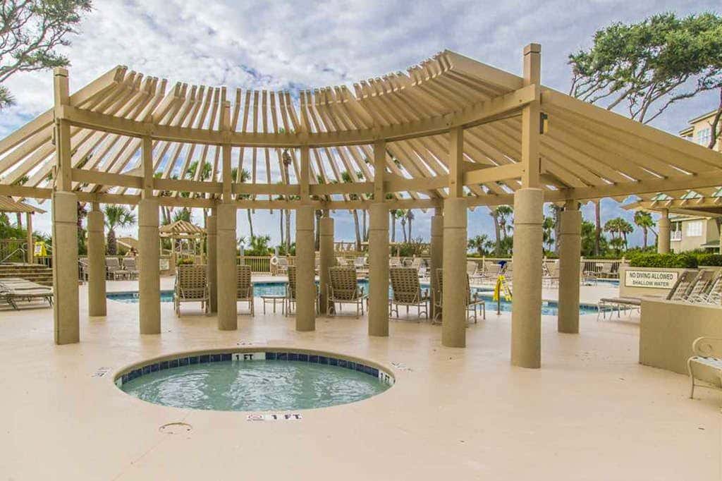 Dreamy condo on the beach with balcony view, shared pool, & charming decor