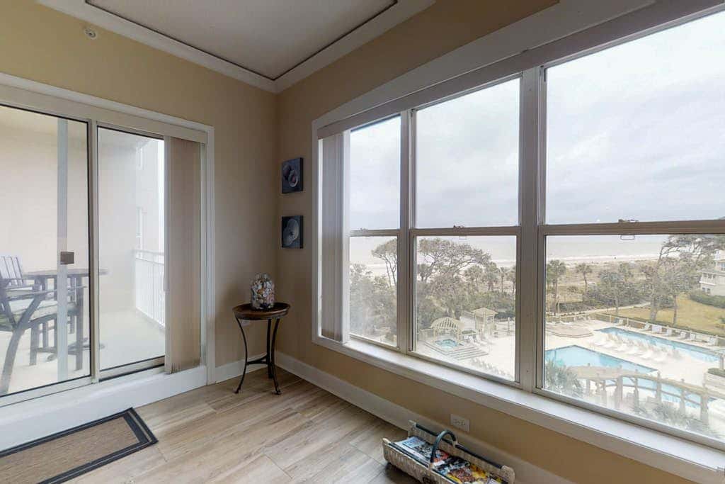 Dreamy condo on the beach with balcony view, shared pool, & charming decor