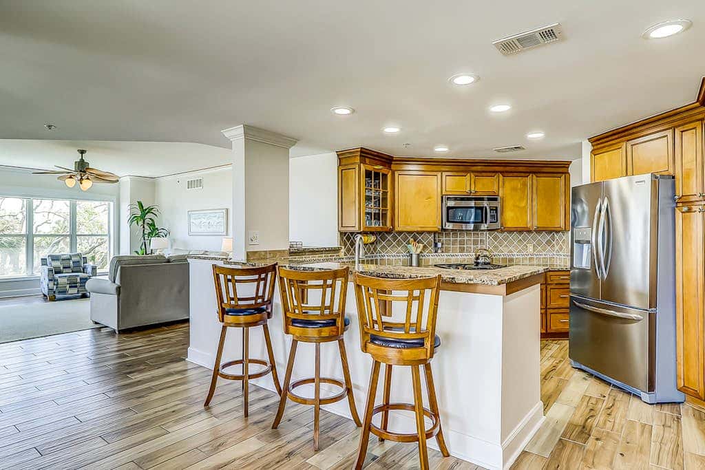 Corner condo with panoramic view & wraparound deck, just steps from the water
