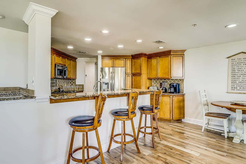 Corner condo with panoramic view & wraparound deck, just steps from the water