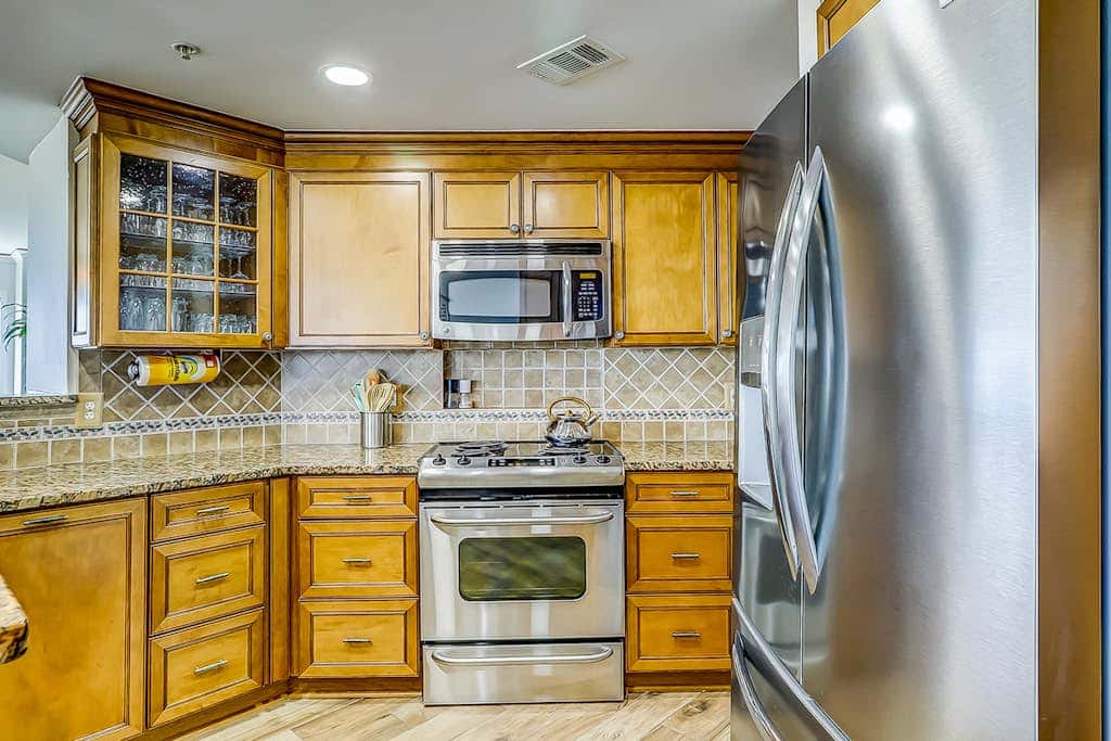 Corner condo with panoramic view & wraparound deck, just steps from the water