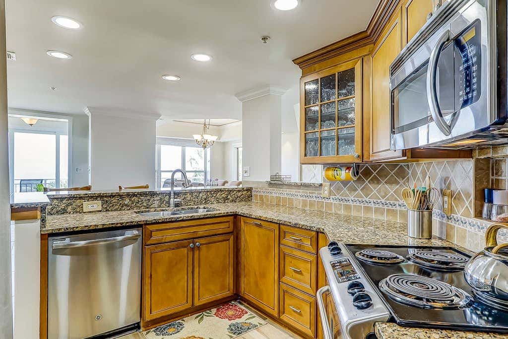 Corner condo with panoramic view & wraparound deck, just steps from the water