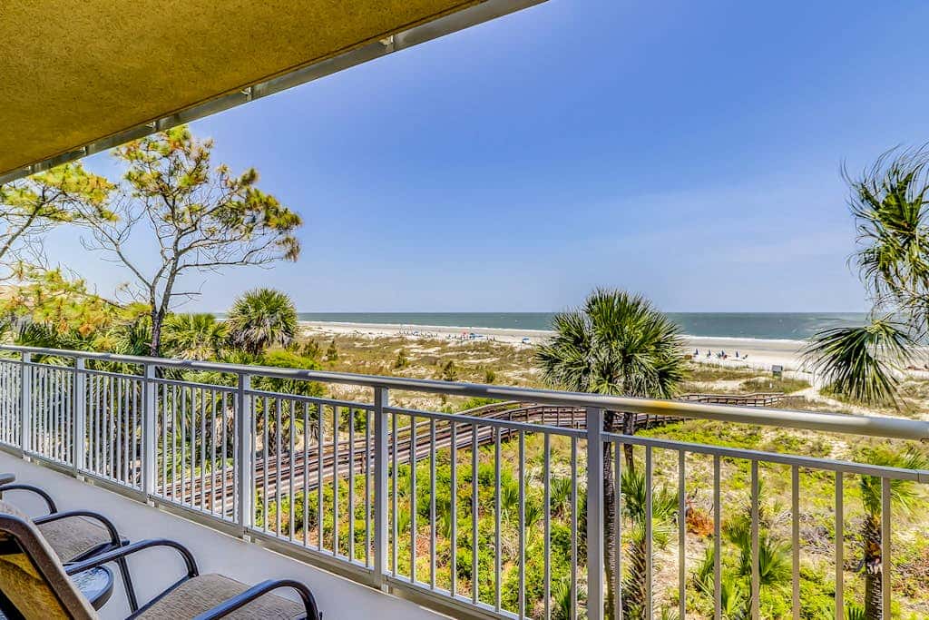Corner condo with panoramic view & wraparound deck, just steps from the water