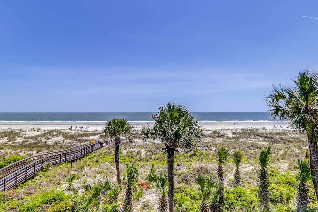 Corner condo with panoramic view & wraparound deck, just steps from the water