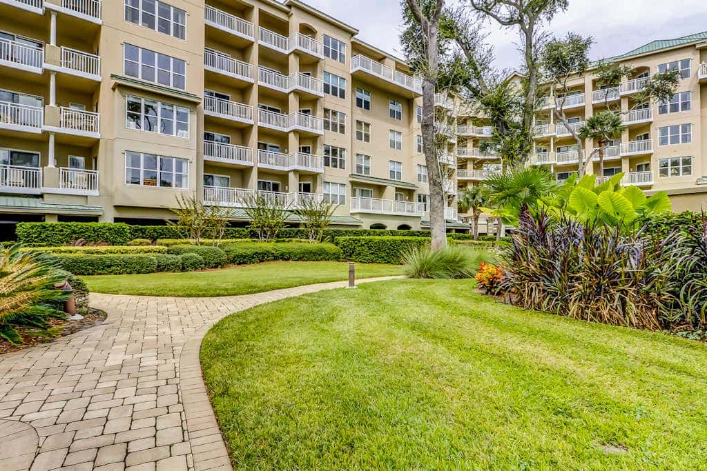 Corner condo with panoramic view & wraparound deck, just steps from the water