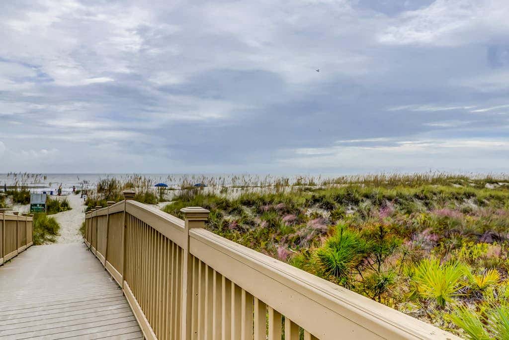 Corner condo with panoramic view & wraparound deck, just steps from the water