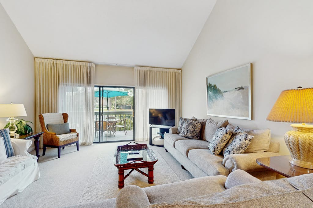 Condo with soaring ceilings, a deck, lagoon views, & shared tennis