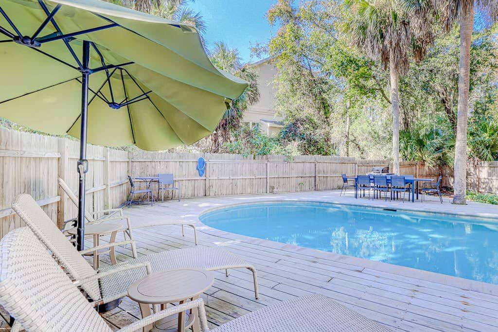 Dog friendly home with an enclosed yard, pool deck, & private pool