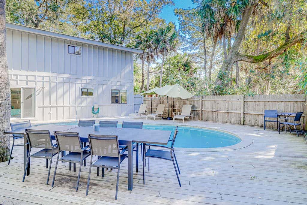Dog friendly home with an enclosed yard, pool deck, & private pool