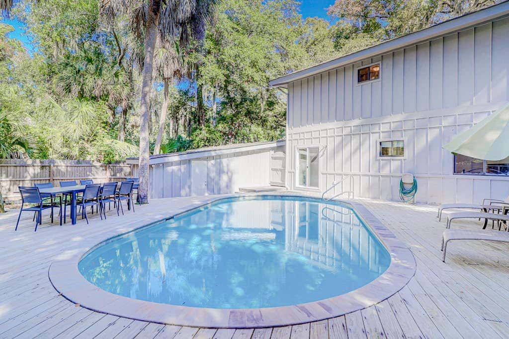 Dog friendly home with an enclosed yard, pool deck, & private pool