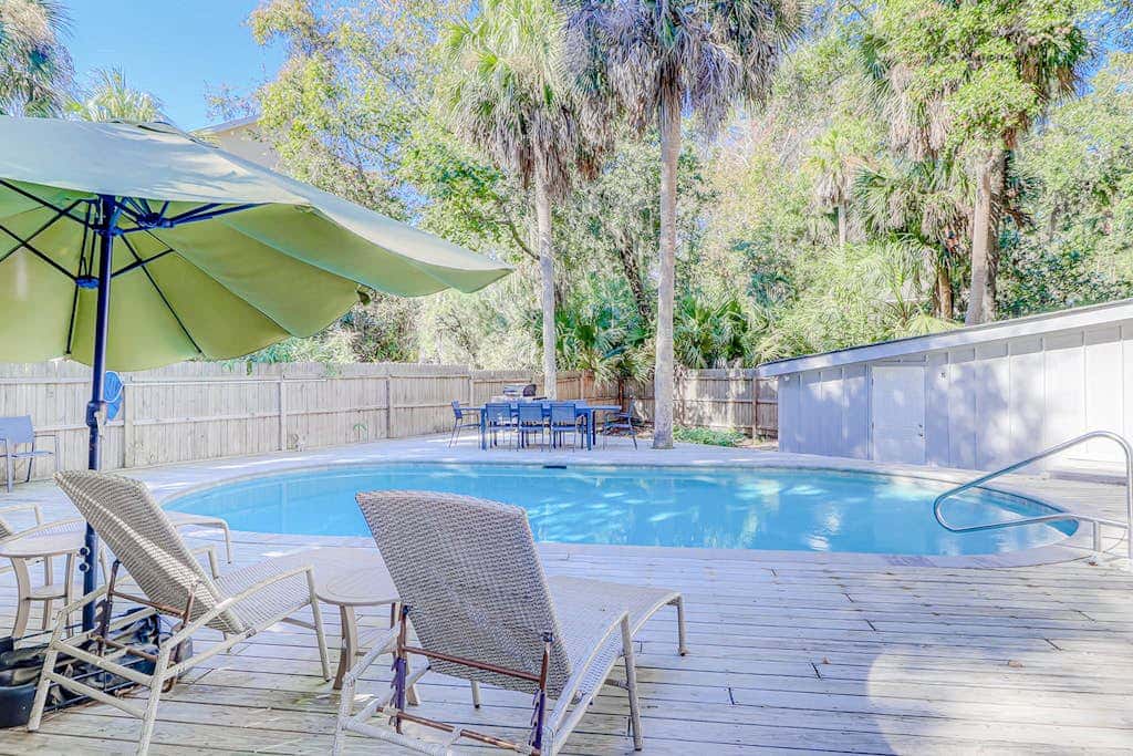 Dog friendly home with an enclosed yard, pool deck, & private pool