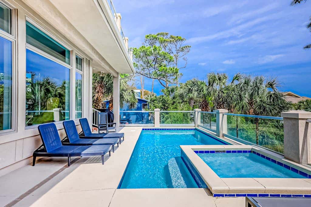 Prime location w/ private pool, elevator, game room and upper level water view 