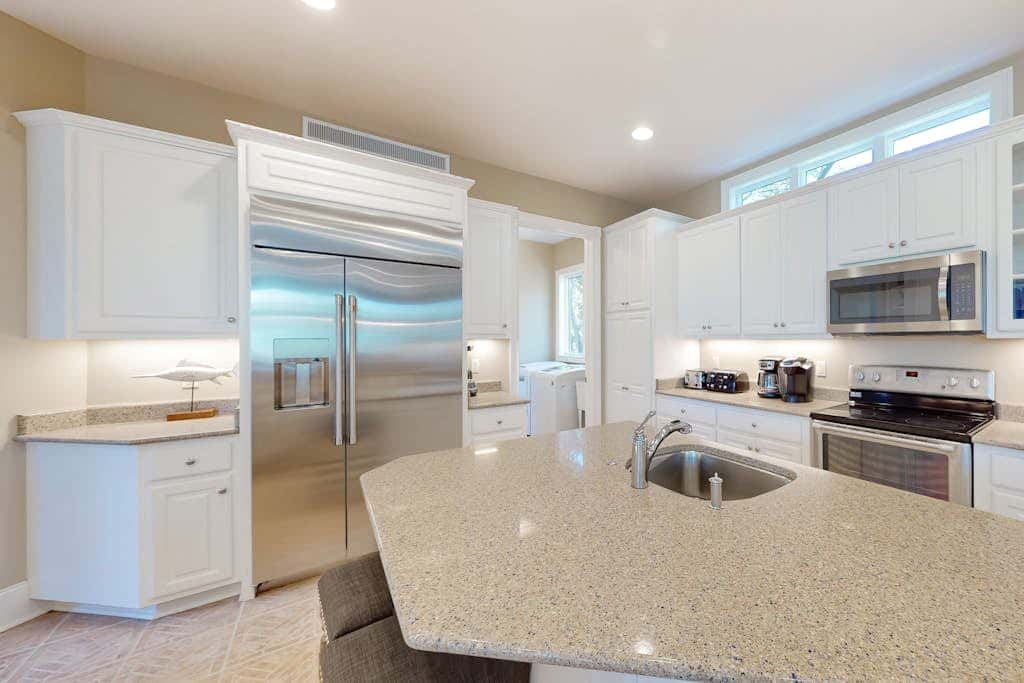 Prime location w/ private pool, elevator, game room and upper level water view 