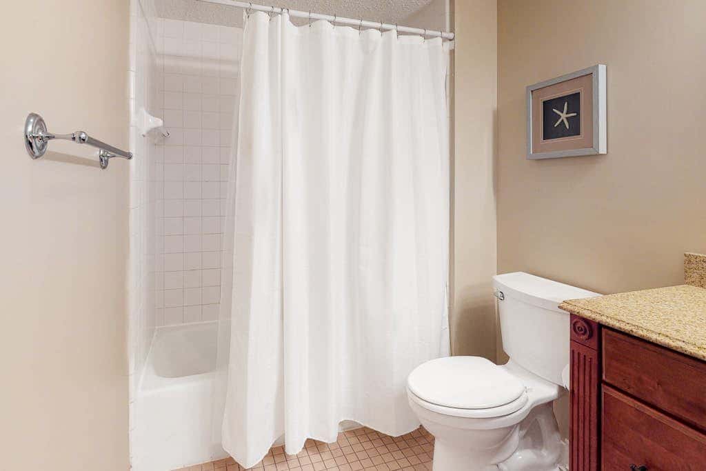 Second-floor condo with balcony, shared outdoor pool, central AC