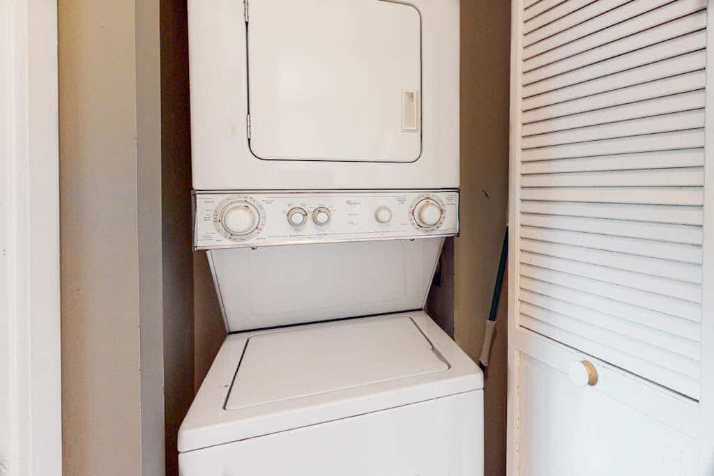 Second-floor condo with balcony, shared outdoor pool, central AC