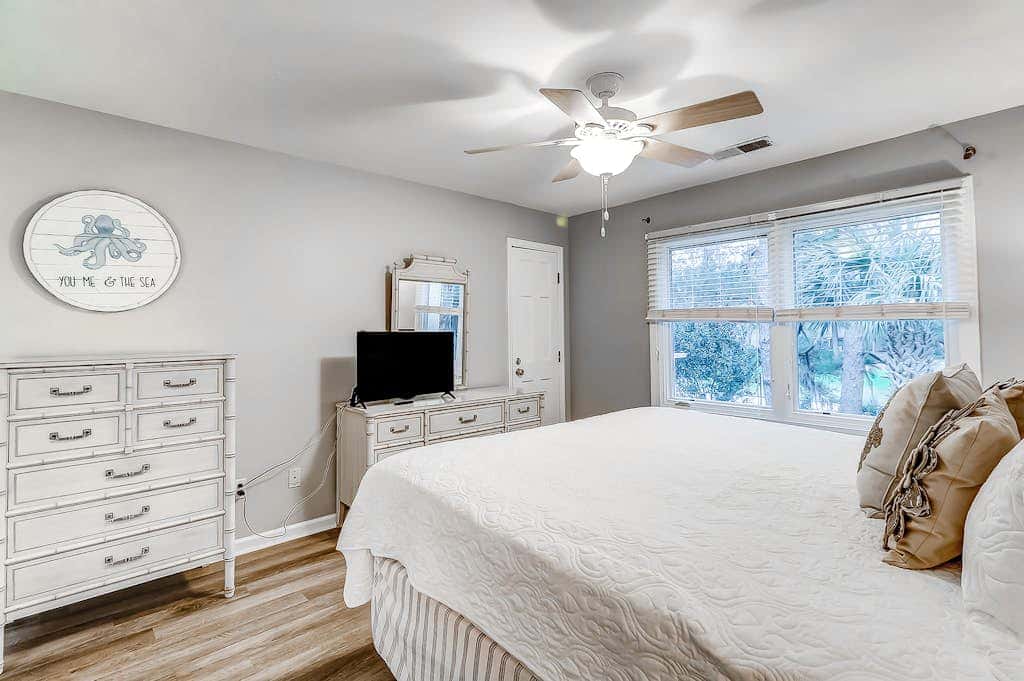 Sun-kissed bliss at Colonnade Club with dual suites, deck, shared pool, hot tub