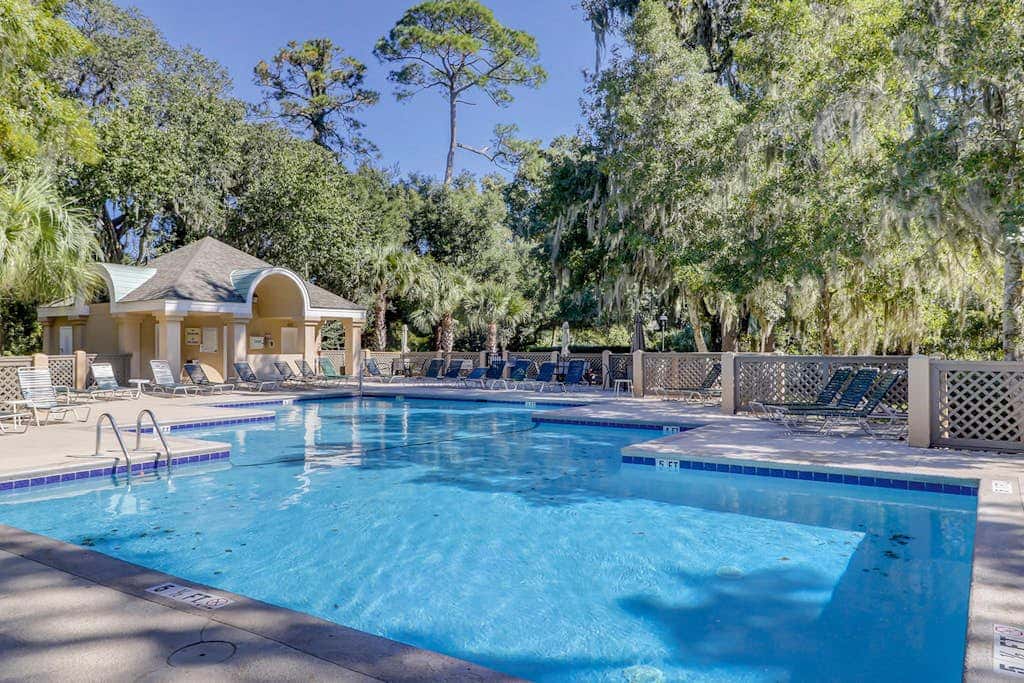 Sun-kissed bliss at Colonnade Club with dual suites, deck, shared pool, hot tub