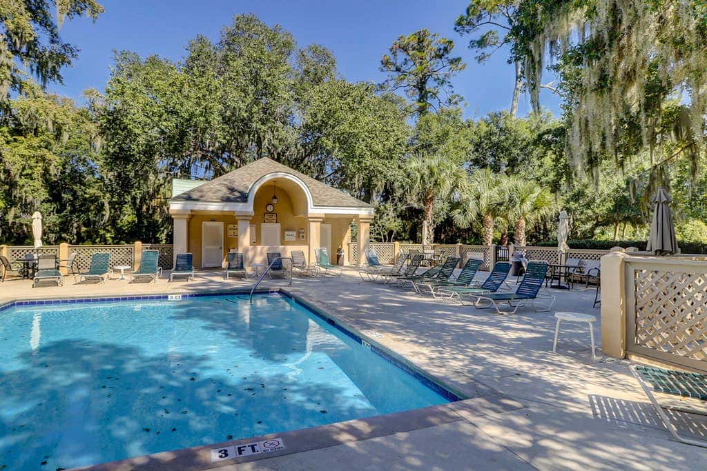 Sun-kissed bliss at Colonnade Club with dual suites, deck, shared pool, hot tub