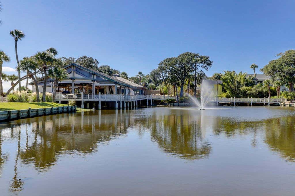 Sun-kissed bliss at Colonnade Club with dual suites, deck, shared pool, hot tub