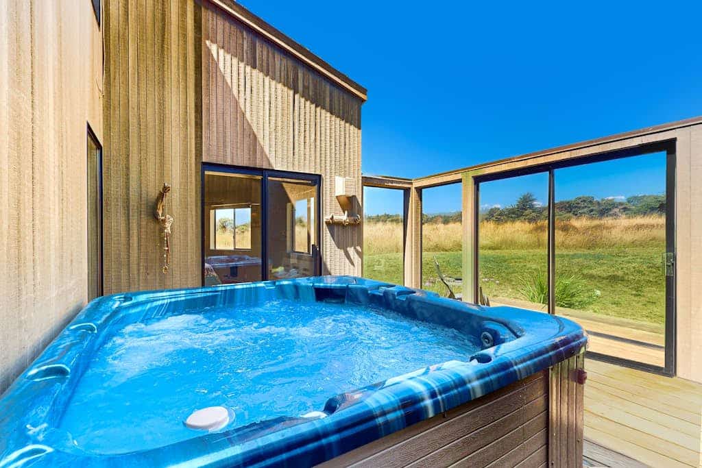 Golden light spills through the windows as the Pacific stretches out before you. End the day in your private hot tub with the ocean as your soundtrack. A warm fire and ocean views anchor cozy evenings in. Room for 6 in this 2-bedroom home. Near the heated community pool. Sea Ranch's iconic trails, tidepools, and heated pools are all at your doorstep. Step outside and the Pacific stretches before you -- this is the Sonoma Coast at its most dramatic.