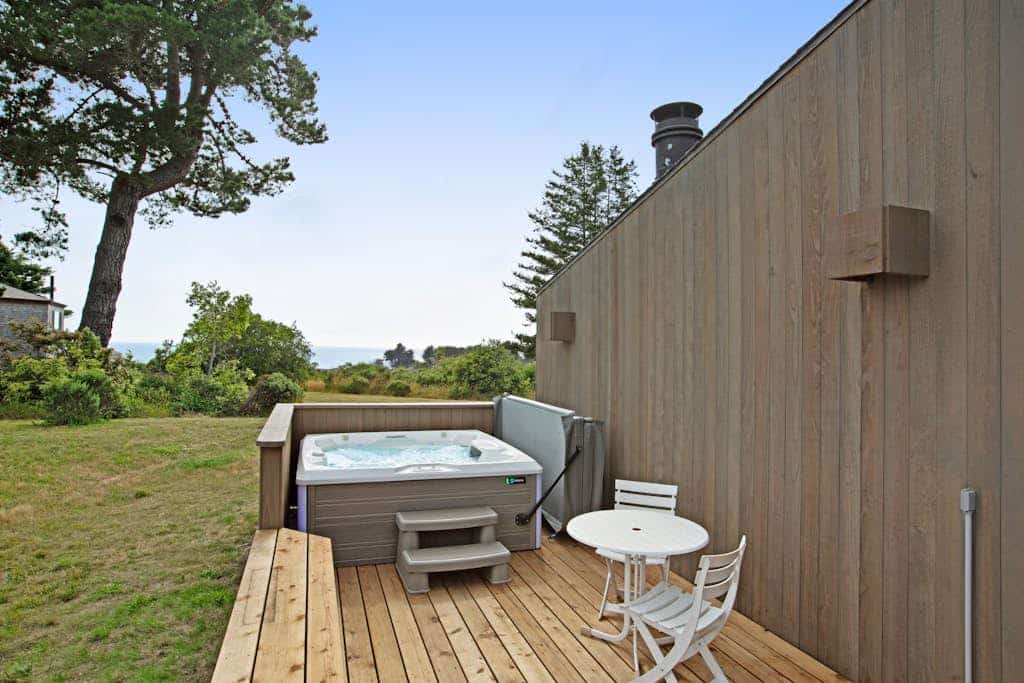 This Sea Ranch home frames the Pacific like a painting -- and the view changes by the hour. Soak in the hot tub as the sun dips below the Pacific. A warm fire and ocean views anchor cozy evenings in. Room for 6 in this 2-bedroom home. Just a 8-minute walk to Shell Beach tidepools. Trails, tidepools, and two heated community pools -- all within reach. Salt air drifts through the windows as the Pacific puts on its daily show just beyond the deck.
