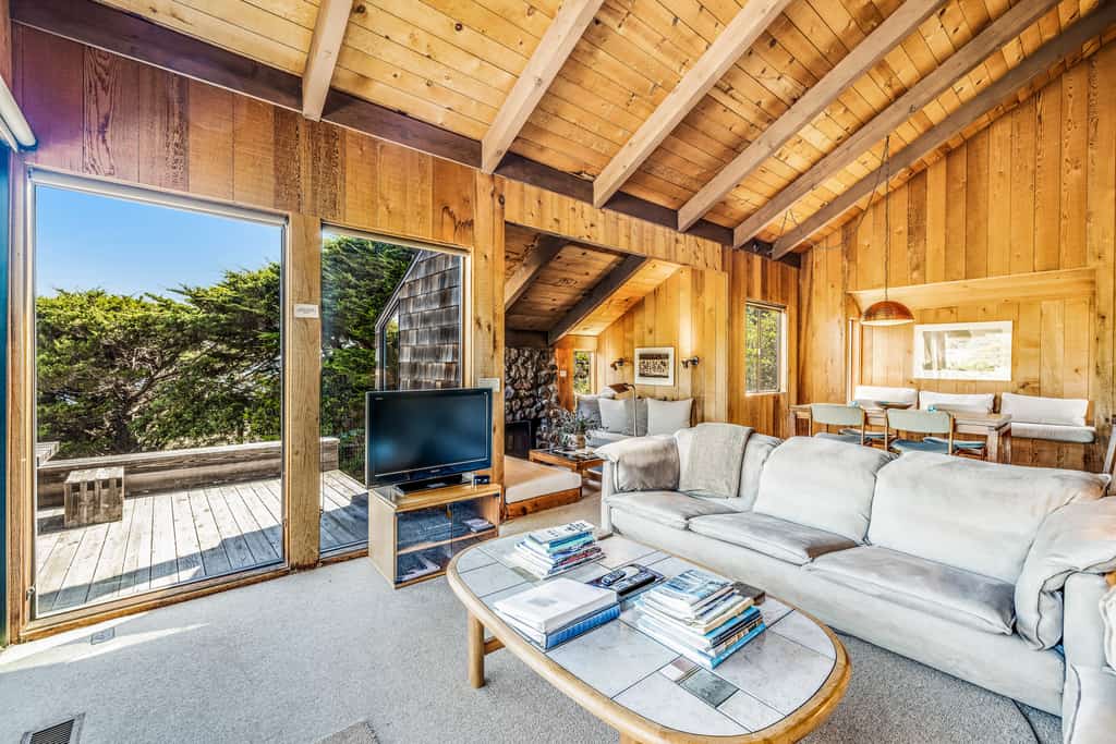 Perched between Shell Beach and Stengel Beach, this Sea Ranch retreat pairs a rare, sweeping ocean view with the architecture the community is famous for: cedar walls, soaring ceilings, and a fireplace built for long, easy evenings. With two private bedroom suites and a loft designed for up to four guests, you have room to spread out with someone you love or share the week with another couple, and still come back together as the day winds down. 