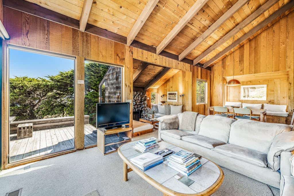 Perched between Shell Beach and Stengel Beach, this Sea Ranch retreat pairs a rare, sweeping ocean view with the architecture the community is famous for: cedar walls, soaring ceilings, and a fireplace built for long, easy evenings. With two private bedroom suites and a loft designed for up to four guests, you have room to spread out with someone you love or share the week with another couple, and still come back together as the day winds down. 